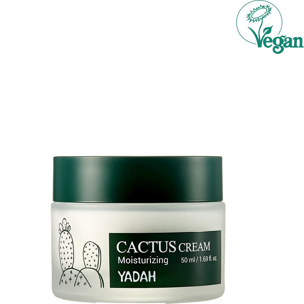 Pot de crème avec couvercle vert. Inscription: CACTUS CREAM, Moisturizing, YADAH. Illustration de cactus. 50 ml / 1.69 fl. oz. Logo Vegan.
