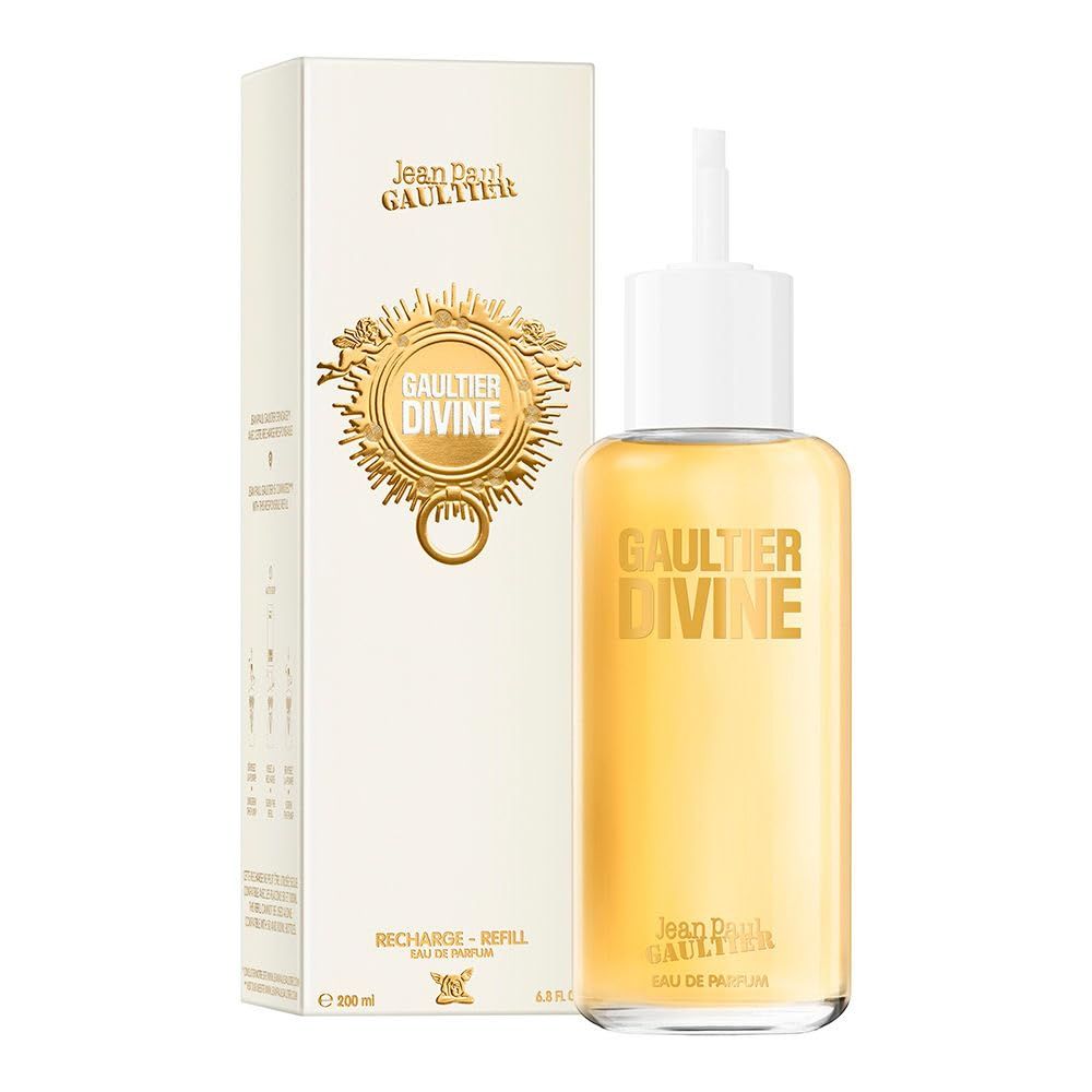 Parfumfles met witte dop en doos. Opschrift: Gaultier Divine. Gouden letters en versiering.