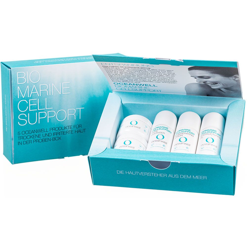 Boîte de produits OCEANWELL ouverte. Contient de petits flacons et pots. Inscription : BIO MARINE CELL SUPPORT. Texte : 5 produits OCEANWELL pour peaux sèches et irritées.