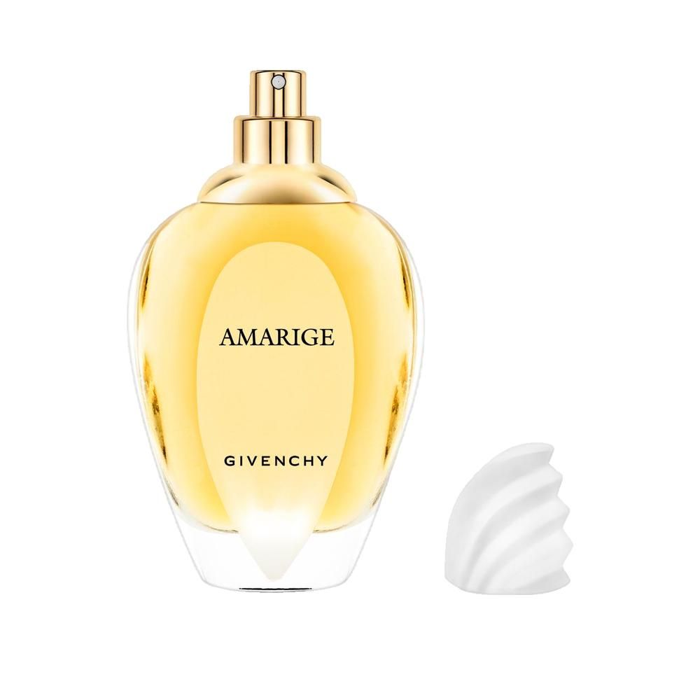 Givenchy Amarige fles. Druppelvormige glazen fles met gouden dop. Witte, losgemaakte dop ernaast.
