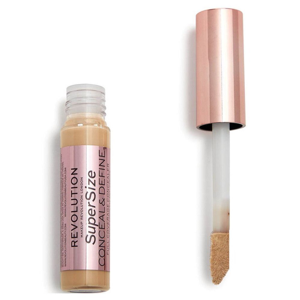 Flacon d'anticernes avec applicateur. Bouchon or rose. Nom du produit et marque visibles.