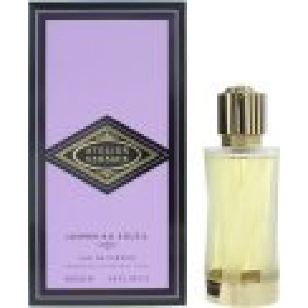 Flacon de parfum avec bouchon doré et boîte violette ornée d'un losange doré.