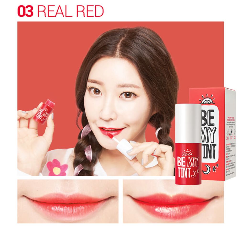 Femme tenant un rouge à lèvres rouge. Inscription : BE MY TINT. Deux gros plans des lèvres sont visibles en dessous. Inscription : 03 REAL RED.