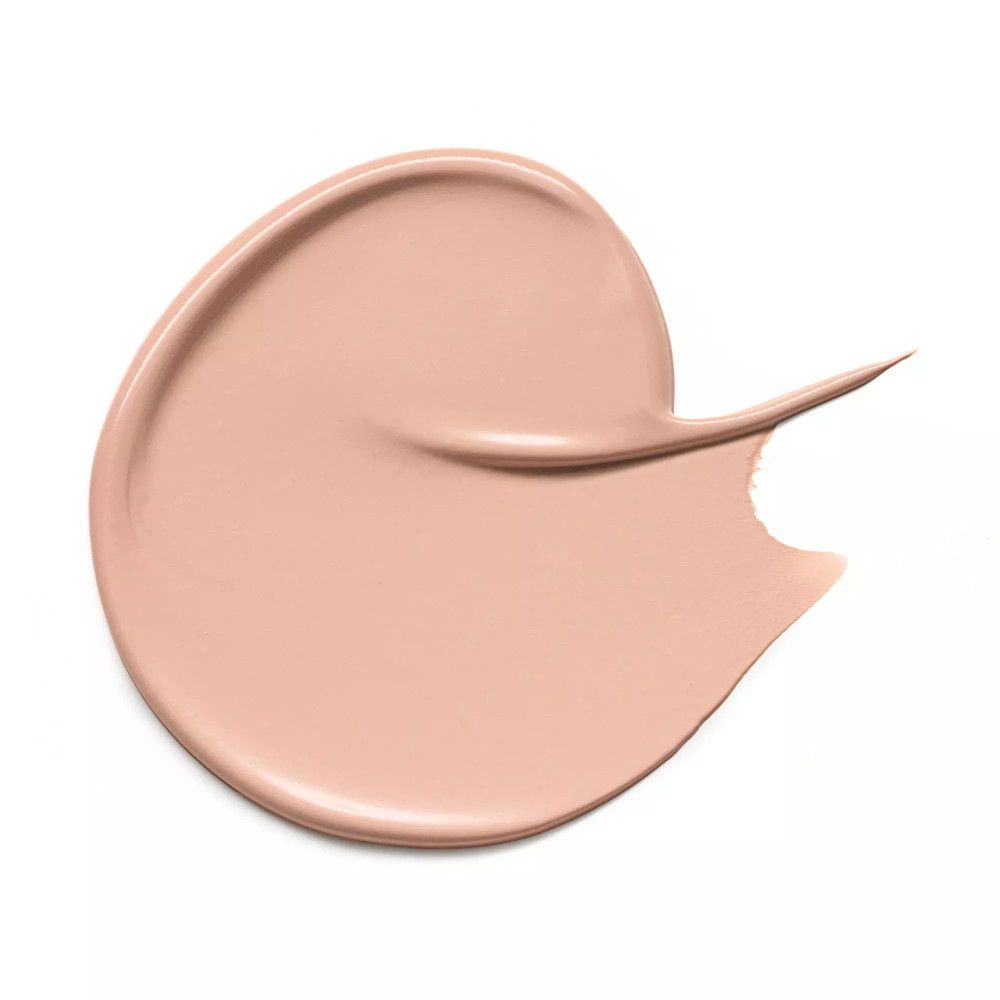 Échantillon de correcteur beige sur fond blanc. Forme arrondie avec pointe.