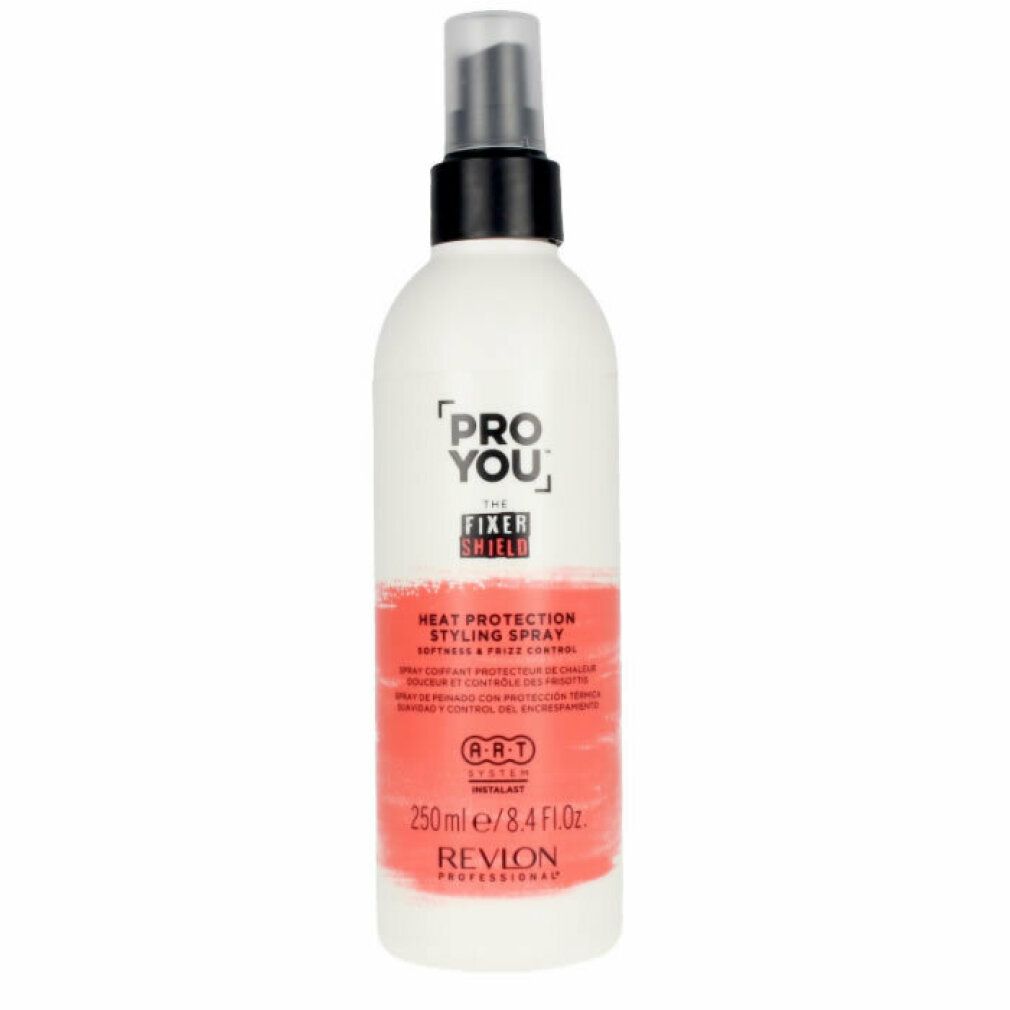 Flacon spray blanc et rouge. Inscription: PRO YOU THE FIXER SHIELD, Heat Protection Styling Spray, Revlon Professional. Tête de pulvérisation noire.