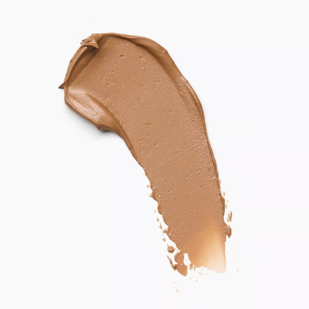 Lichte, bruine kleurstreep. Textuur van het product duidelijk zichtbaar. Op witte achtergrond.