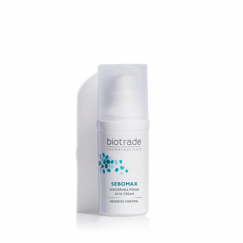 Flacon de crème blanc avec bouchon transparent. Inscription: Biotrade, Sebomax, Sebborhea Prone Skin Cream, Redness Control. Logo bleu.