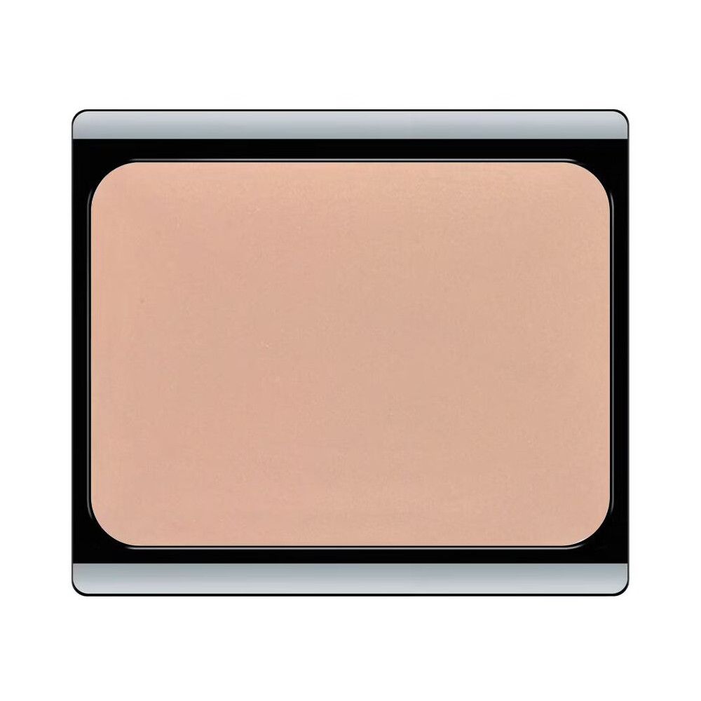 Crème camouflage compacte dans un boîtier noir. Couleur beige clair.