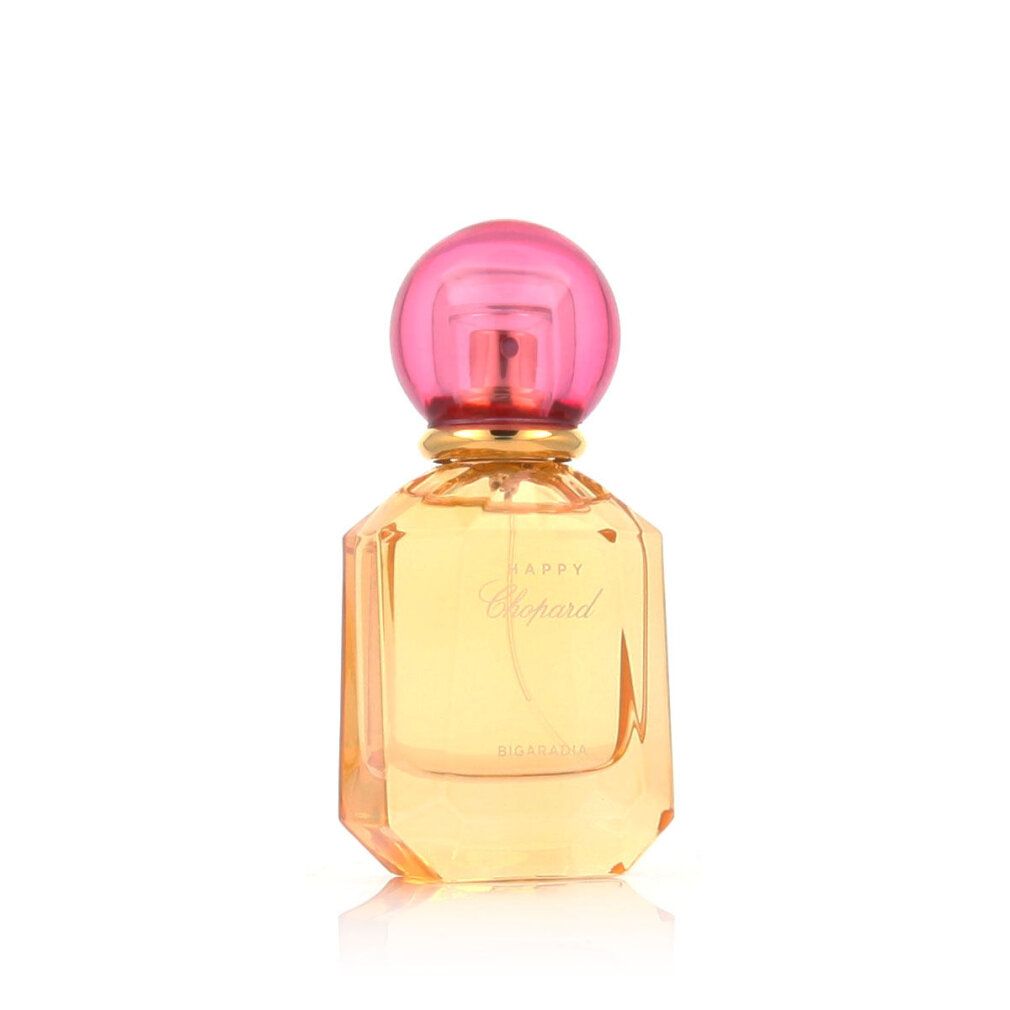Parfumfles met roze dop en gele vloeistof. Opschrift Happy Chopard Bigaradia.