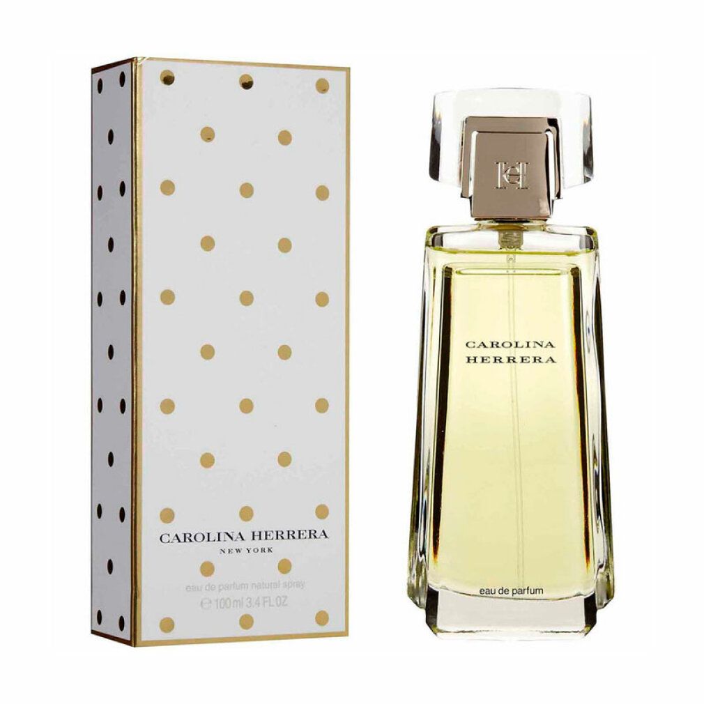 Parfumfles en verpakking. Fles rechthoekig, transparant. Verpakking wit met gouden stippen. Opschrift: CAROLINA HERRERA.