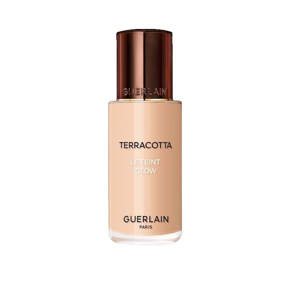 Flacon de fond de teint liquide avec bouchon marron. Inscription: Terracotta Le Teint Glow, Guerlain Paris.