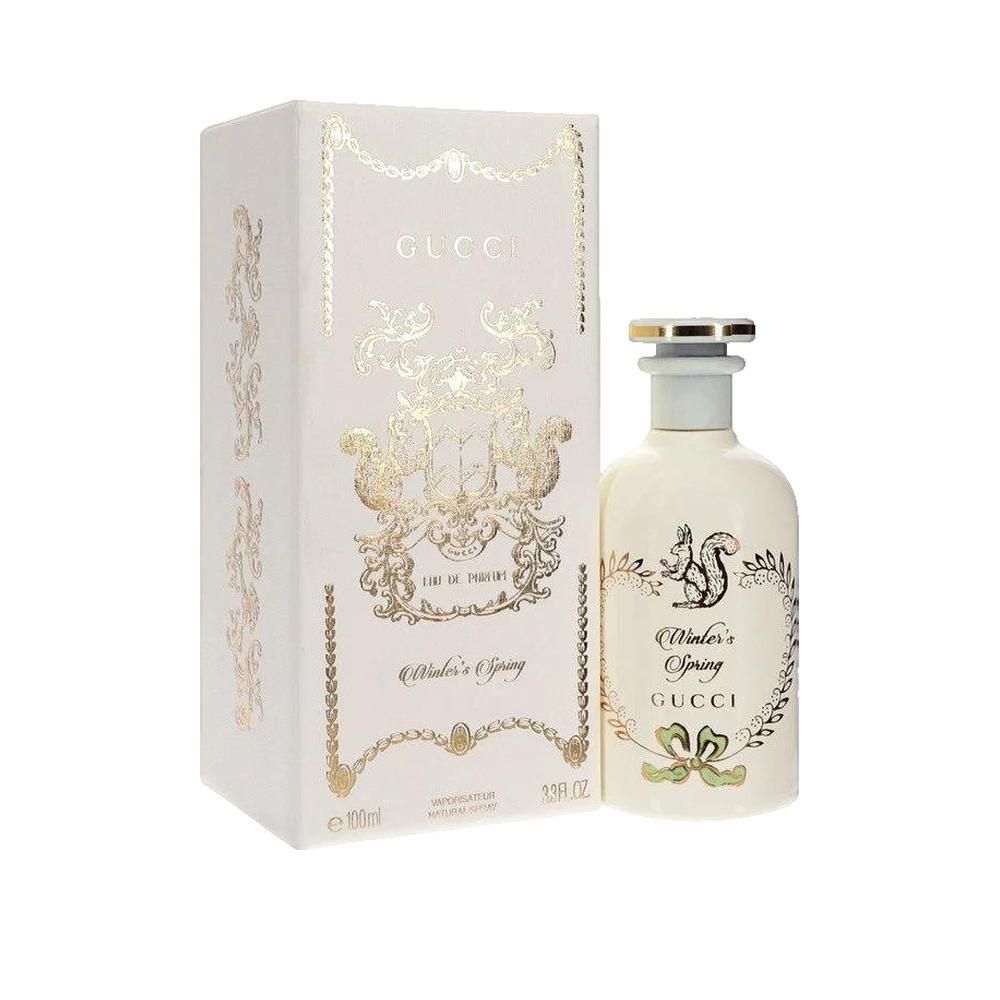 Gucci parfumfles en verpakking. Wit met gouden versieringen. Opschrift: Winter's Spring, Gucci.