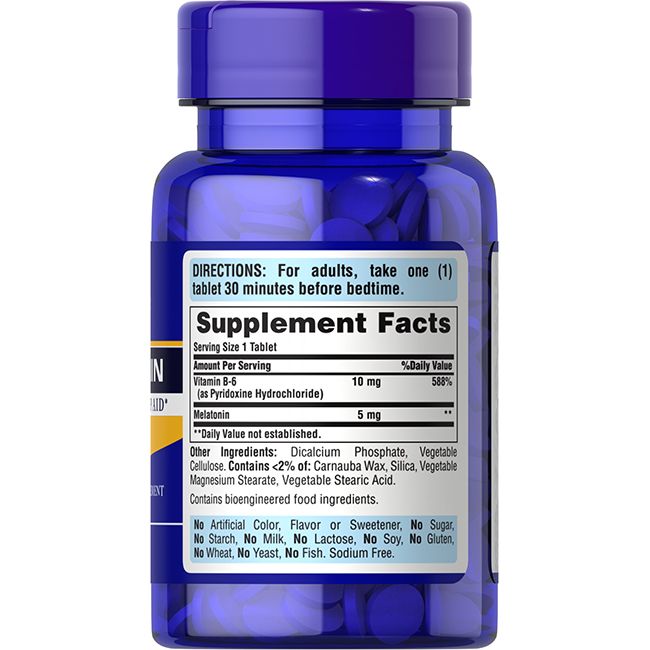 Flacon bleu de comprimés. Étiquette avec ingrédients: Vitamine B-6, Mélatonine. Posologie: 1 comprimé.