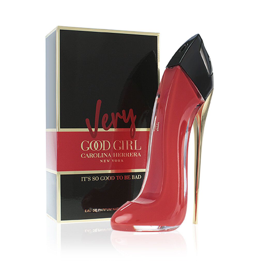 Flacon rouge en forme d'escarpin à côté d'une boîte noire avec texte rouge. "Very Good Girl" est écrit sur la boîte.