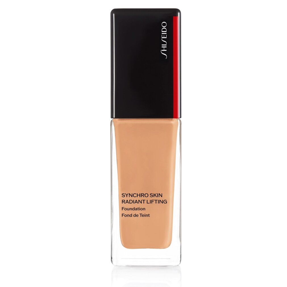 Flacon de fond de teint. Bouchon noir avec bande rouge. Inscription: Synchro Skin Radiant Lifting Foundation. Teinte.