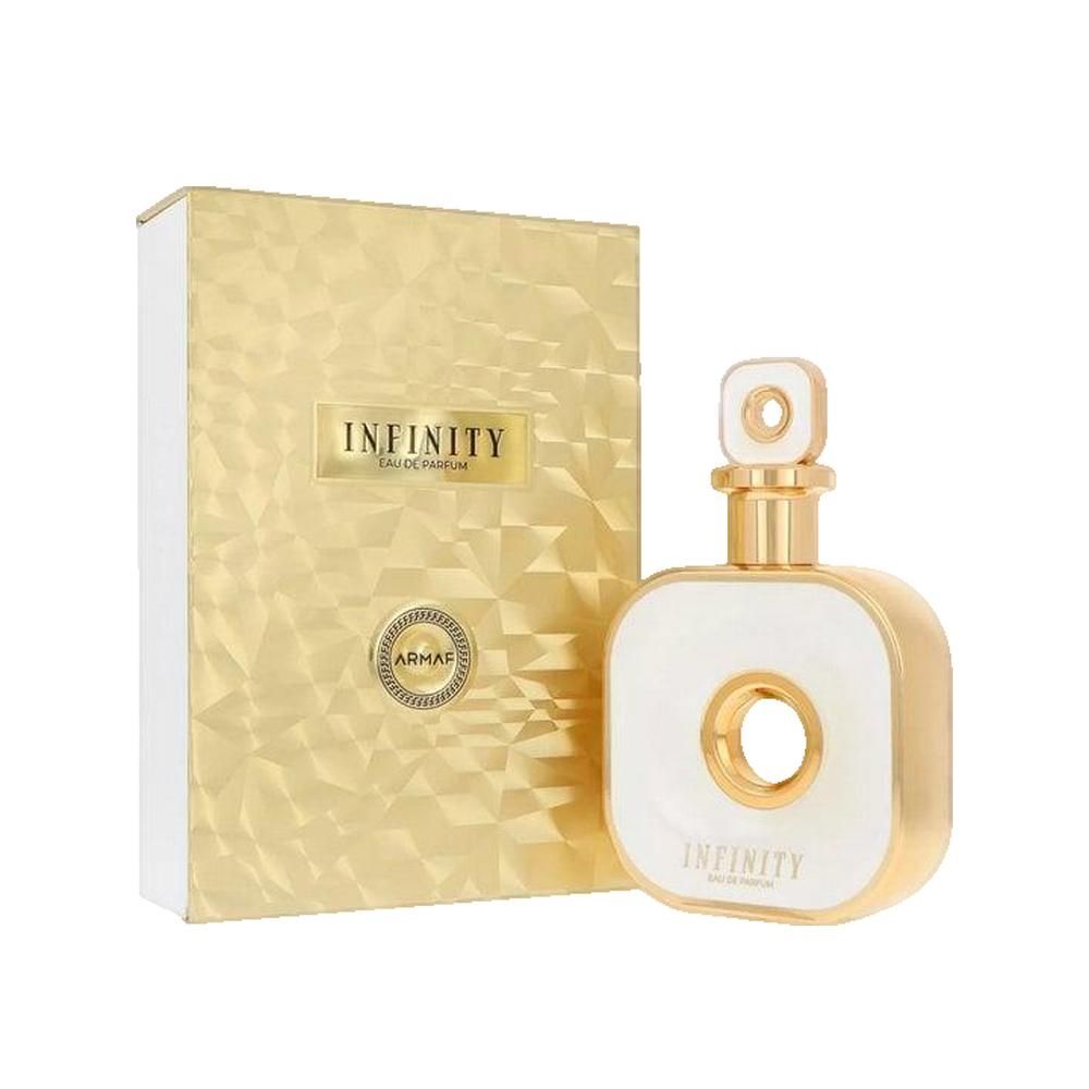 Flacon de parfum et emballage. Flacon carré blanc avec des accents dorés et un trou au centre. Emballage doré.