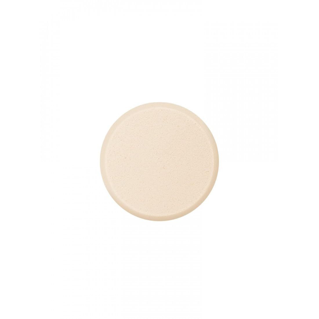 Éponge ronde beige, vue de dessus.
