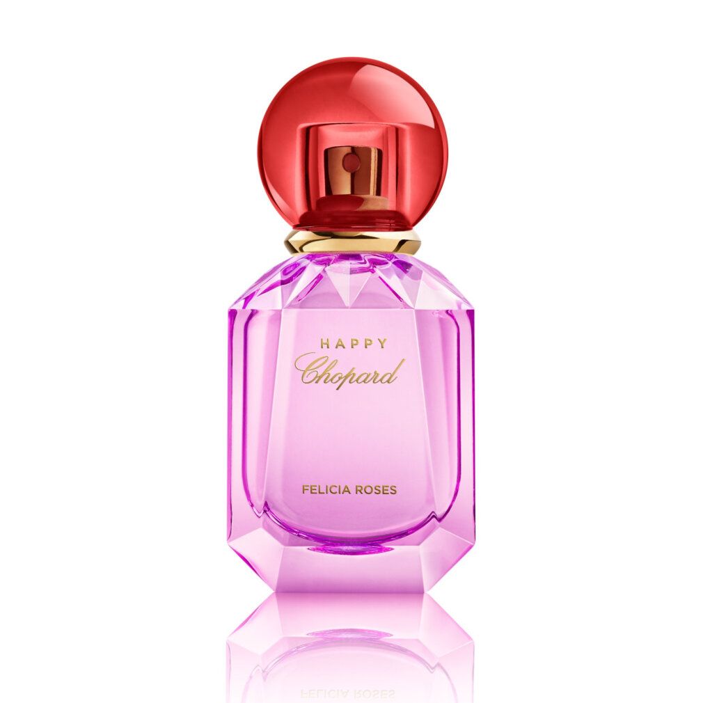 Flacon de parfum rose avec bouchon rouge. Inscription HAPPY Chopard FELICIA ROSES. Flacon facetté.