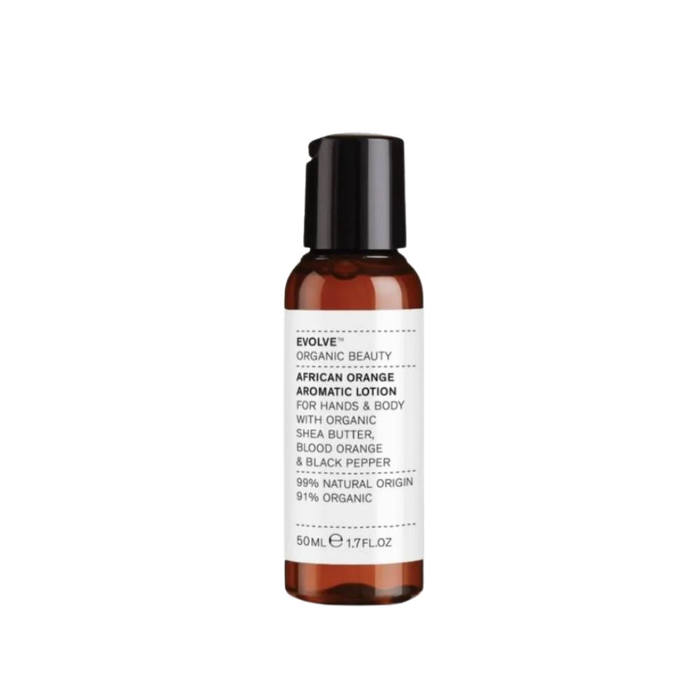 Flacon marron avec bouchon noir. Inscription: African Orange Aromatic Lotion. Contient beurre de karité, orange sanguine et poivre.