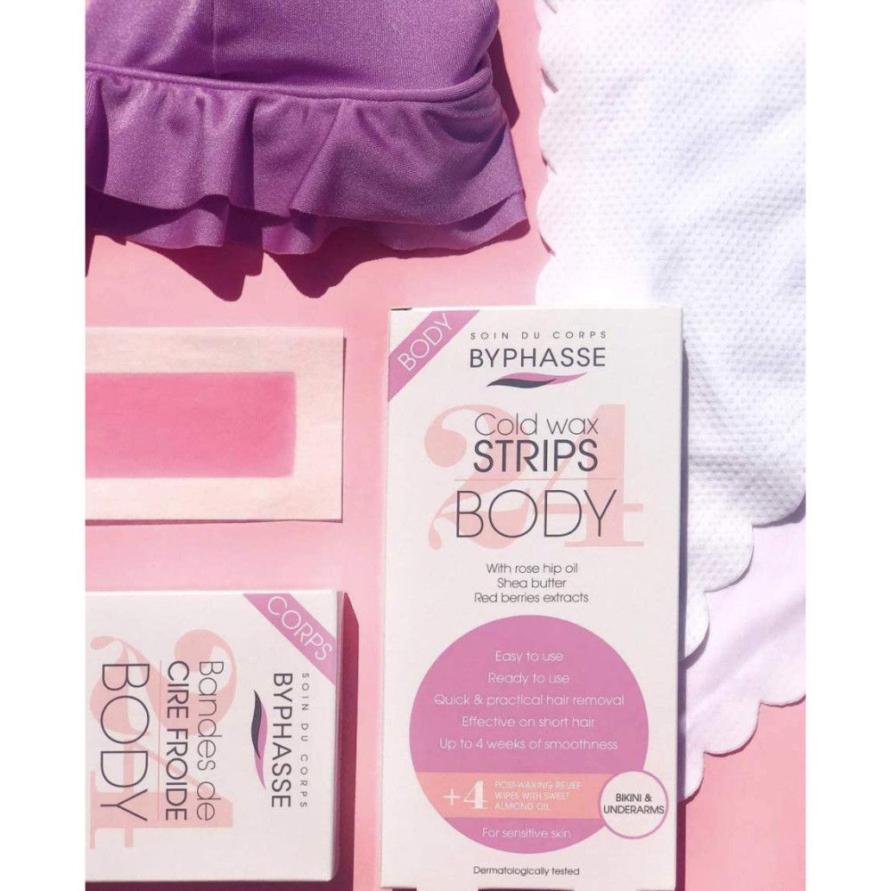 Byphasse Koudewaxstrips Body, losse strips en doekjes op roze achtergrond.
