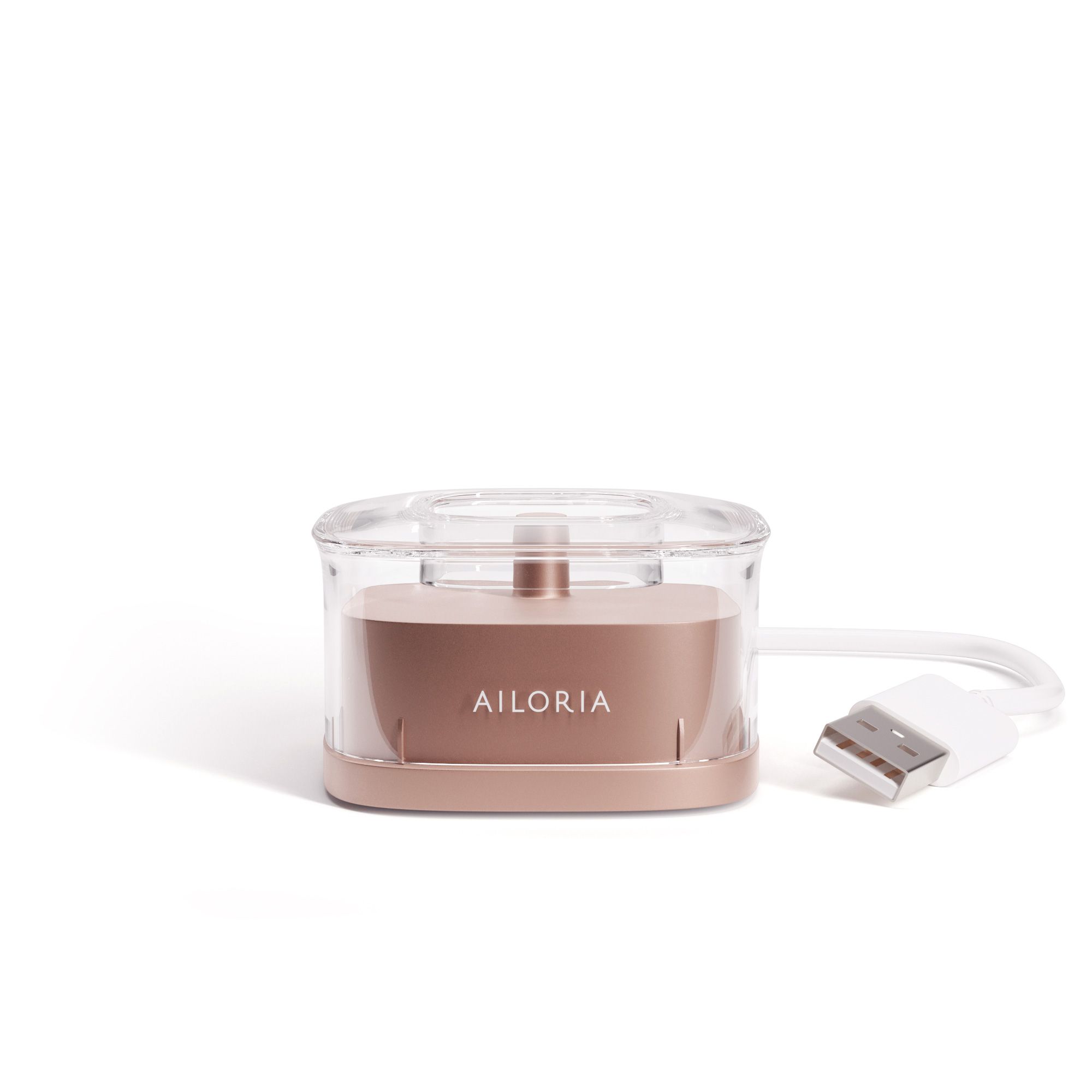 Station de charge inductive avec câble USB. Boîtier rose doré et couvercle transparent. Logo AILORIA.