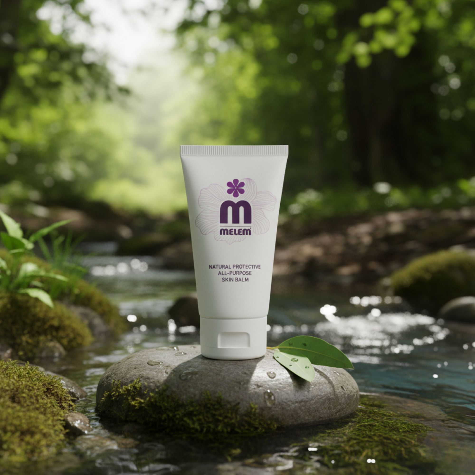 Tube blanc avec logo violet et texte: Melem, Natural Protective All-Purpose Skin Balm. Placé sur une pierre dans une rivière.