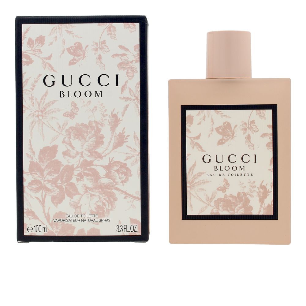 Roze fles en doos. Opschrift Gucci Bloom. Zwarte kader met bloemmotief. Eau de Toilette.