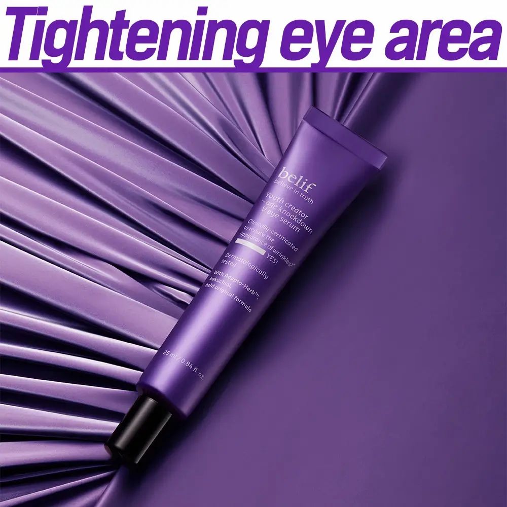 Paarse tube met zwarte dop. Opschrift: belif, Youth creator - age knockdown V eye serum. Op paarse achtergrond met tekst.
