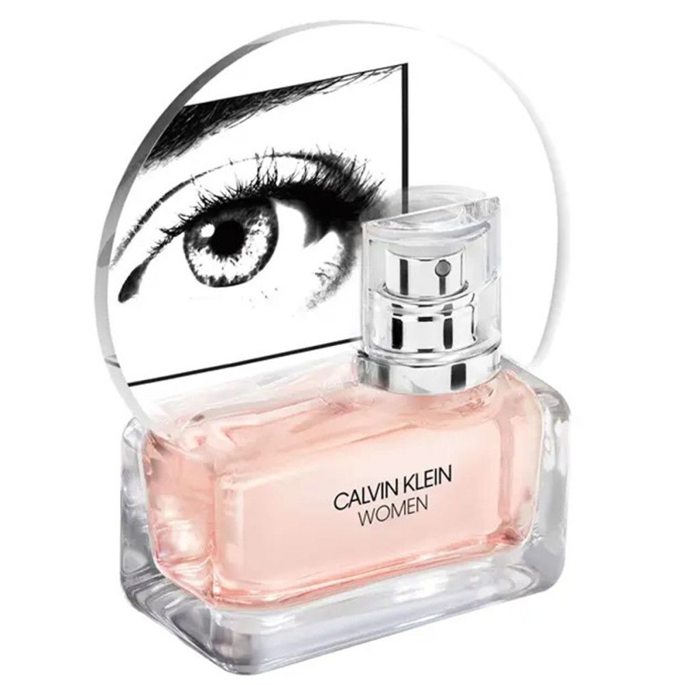 Flacon de parfum rose, bouchon argenté. Inscription: CALVIN KLEIN WOMEN. Fond: Graphique d'un œil.