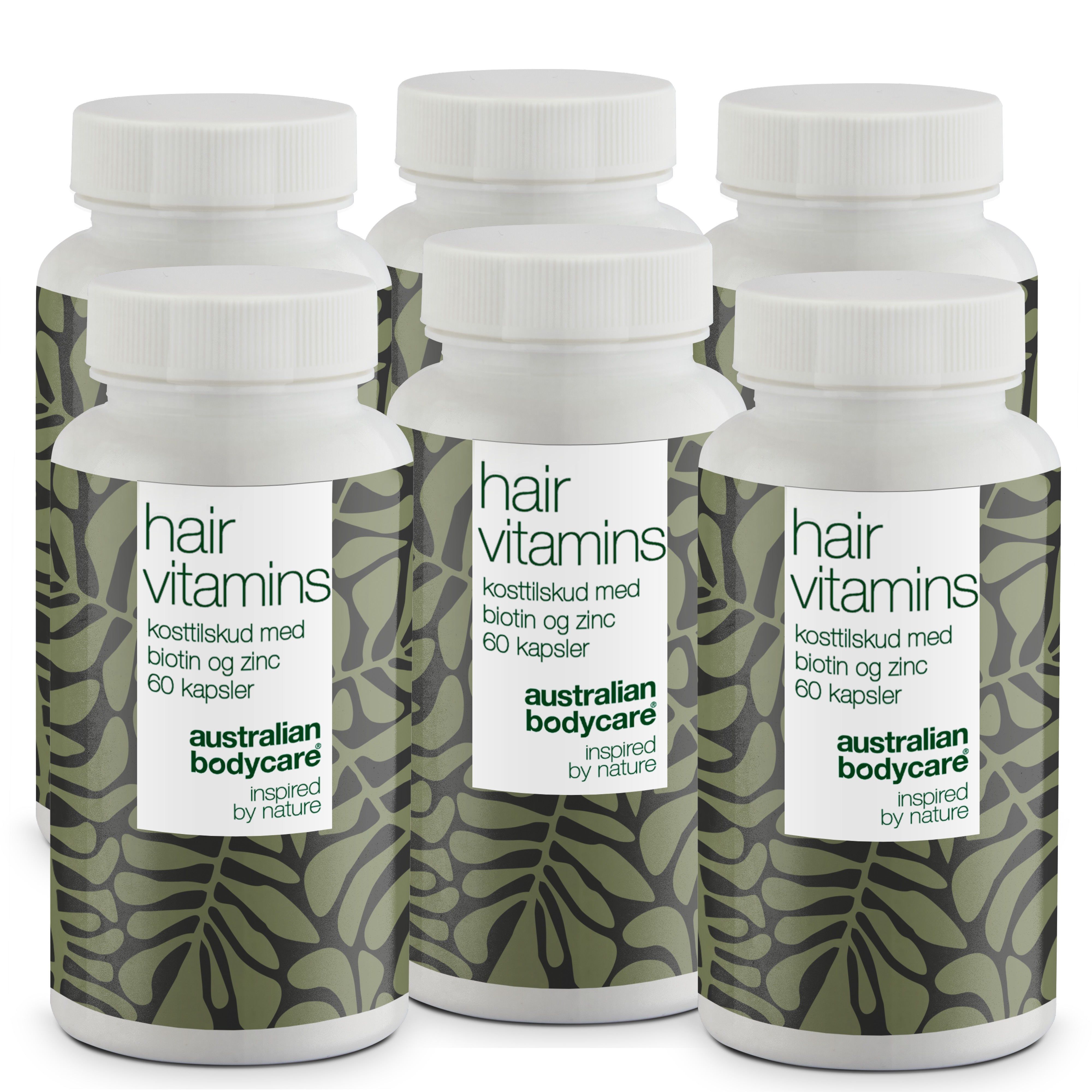 Plusieurs flacons blancs avec des étiquettes. Les étiquettes indiquent "hair vitamins" et "Australian Bodycare".