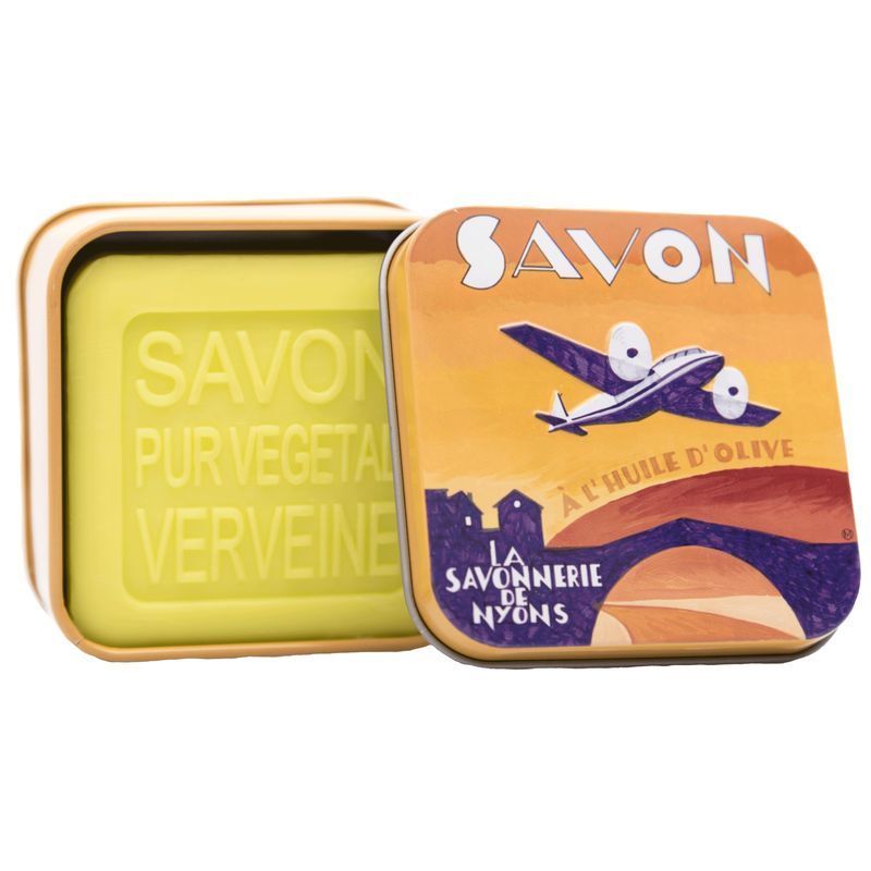 Open metalen doos met zeep. Zeep met tekst SAVON PUR VEGETAL VERVEINE. Doos met vliegtuig en tekst SAVON.