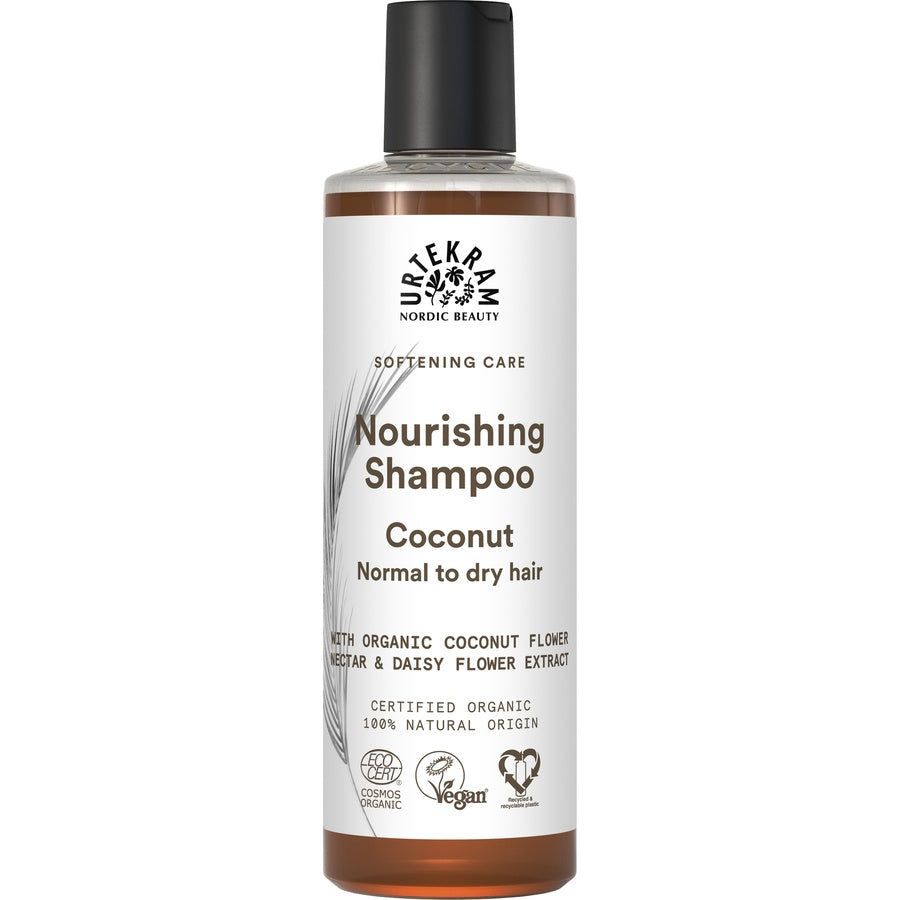 Flacon de shampooing. Inscription: Nourishing Shampoo Coconut. Certifications: Vegan, Cosmos Organic.