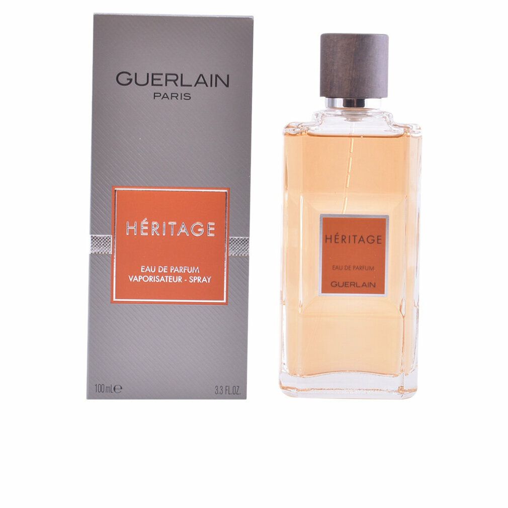 Parfumfles naast verpakking. Fles met bruine dop, oranje label. Guerlain Héritage.