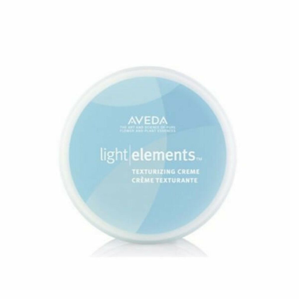 Récipient rond bleu avec couvercle blanc. Inscription: Aveda light elements. Crème texturisante. Crème texturisante.