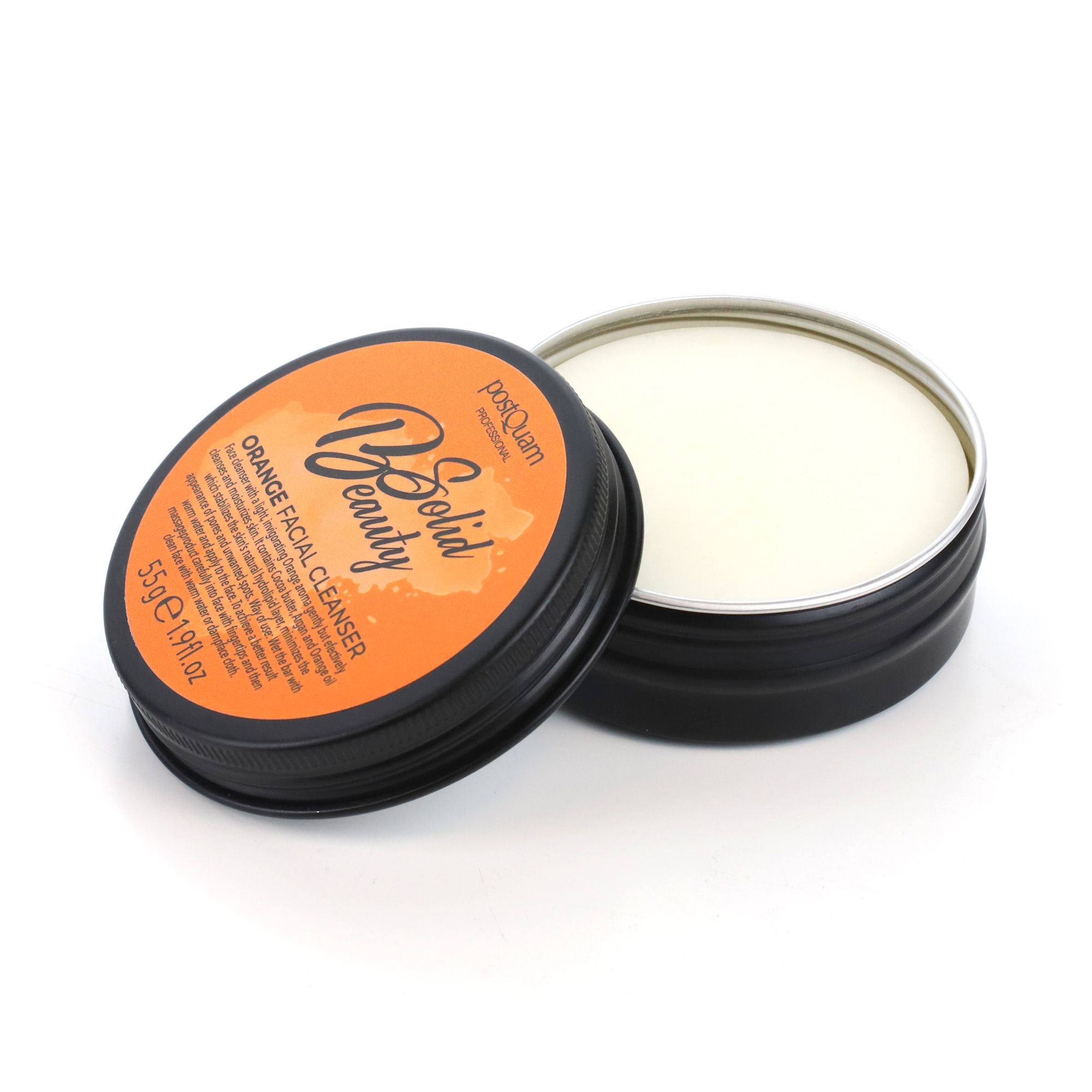 Zwarte ronde doos met deksel. Opschrift "Solid Beauty" en "Orange Facial Cleanser". Crèmekleurige inhoud.