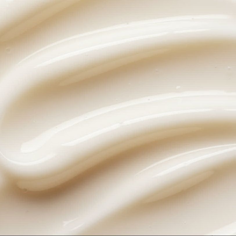 Close-up van romige, witte crème met golvende lijnen.