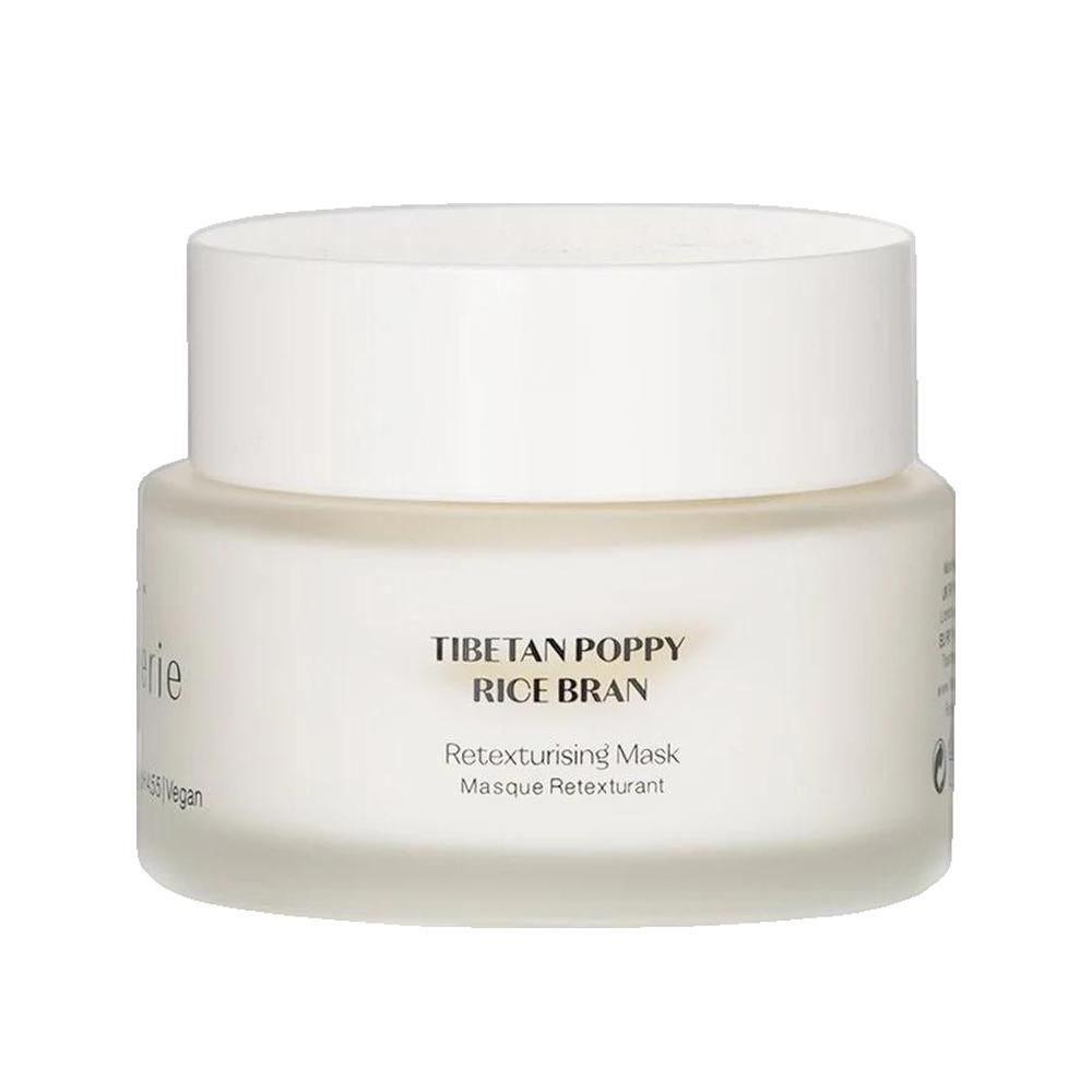 Pot blanc avec couvercle. Inscription: Tibetan Poppy Rice Bran. Masque retexturant. Vegan. Logo Flânerie.