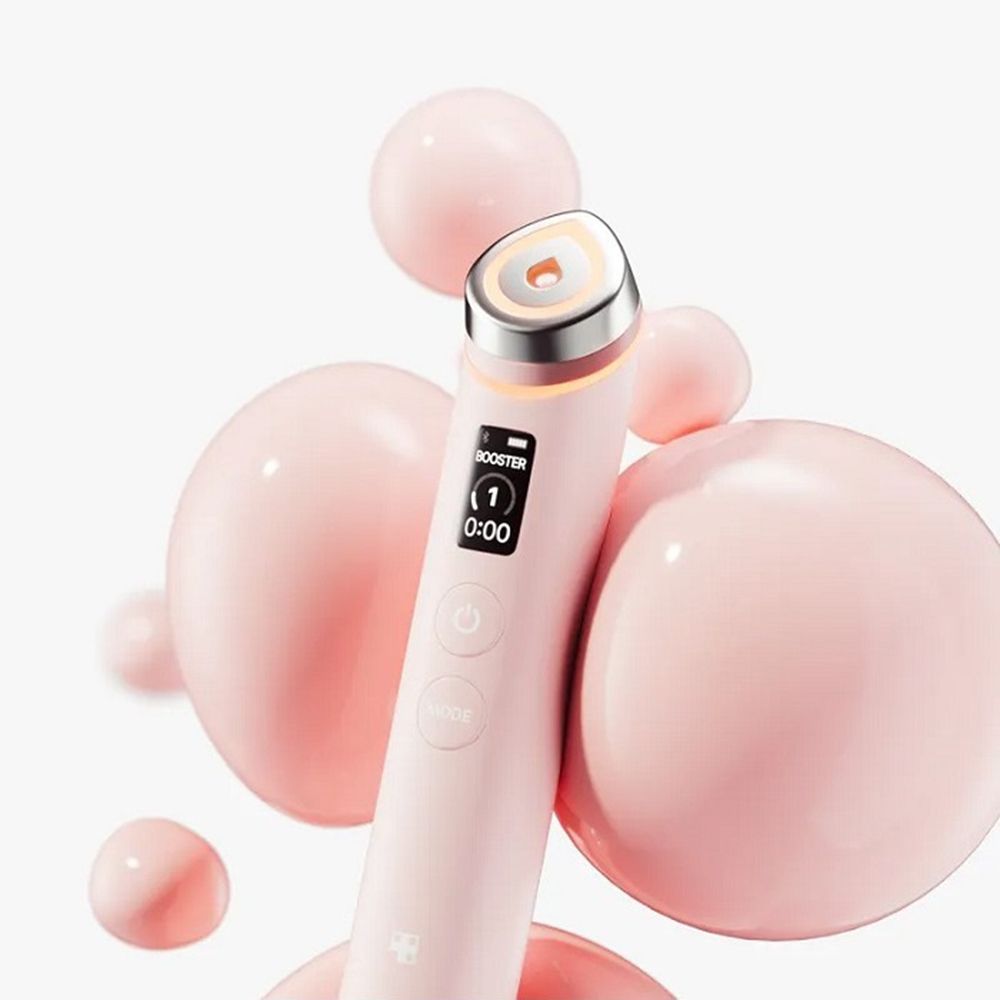 Appareil de soin de la peau avec boîtier rose et lumière blanche. Affichage numérique. Nom du produit non visible.