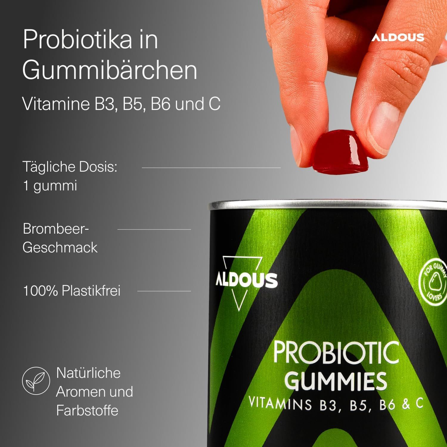 Main prend un bonbon gélifié probiotique Aldous de la boîte. Vitamines B3, B5, B6, C.