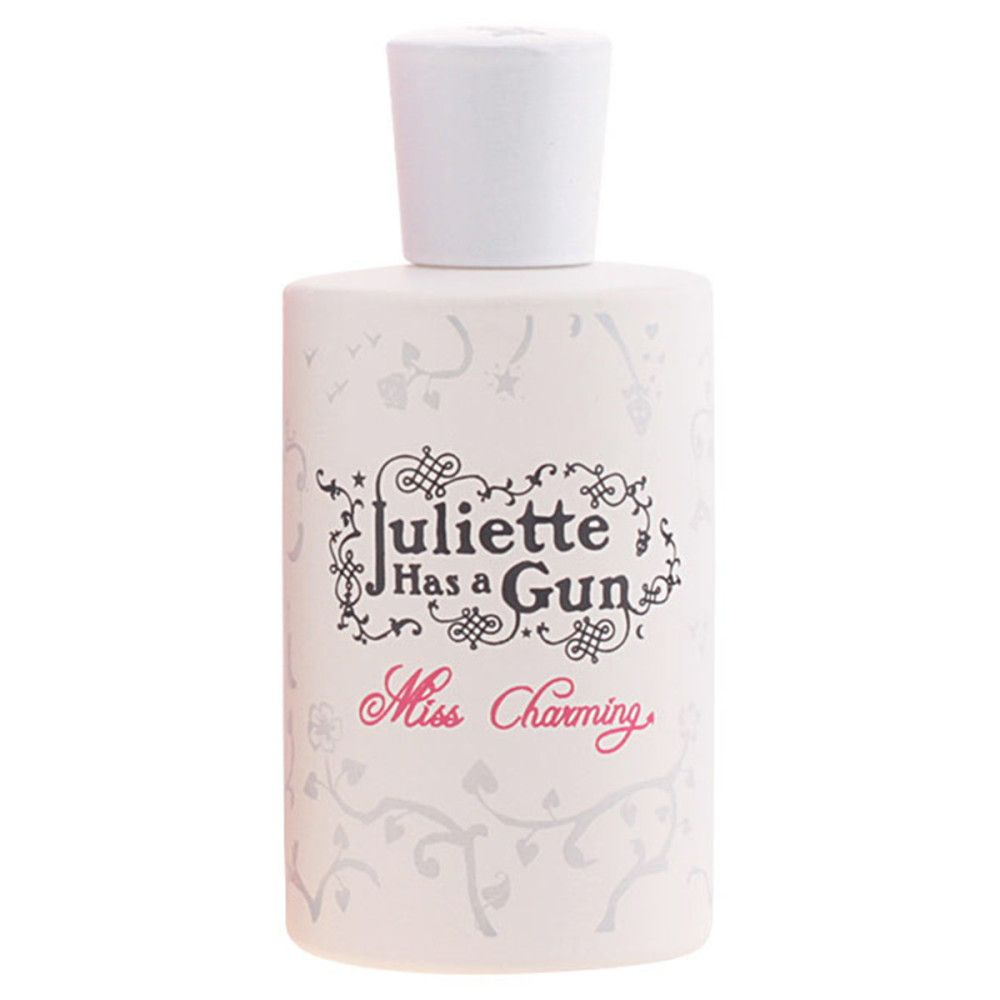 Witte parfumfles. Opschrift: Juliette Has a Gun, Miss Charming. Witte dop.