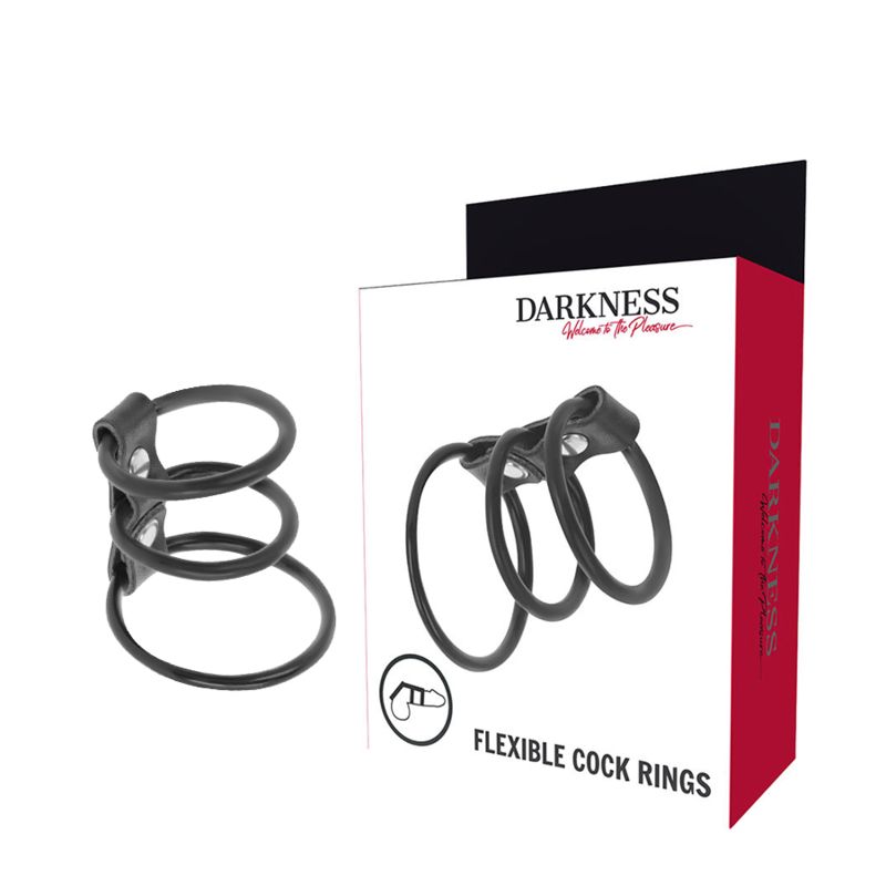 Trois anneaux de pénis noirs et flexibles en silicone, reliés par une bande de cuir avec boutons-pression.