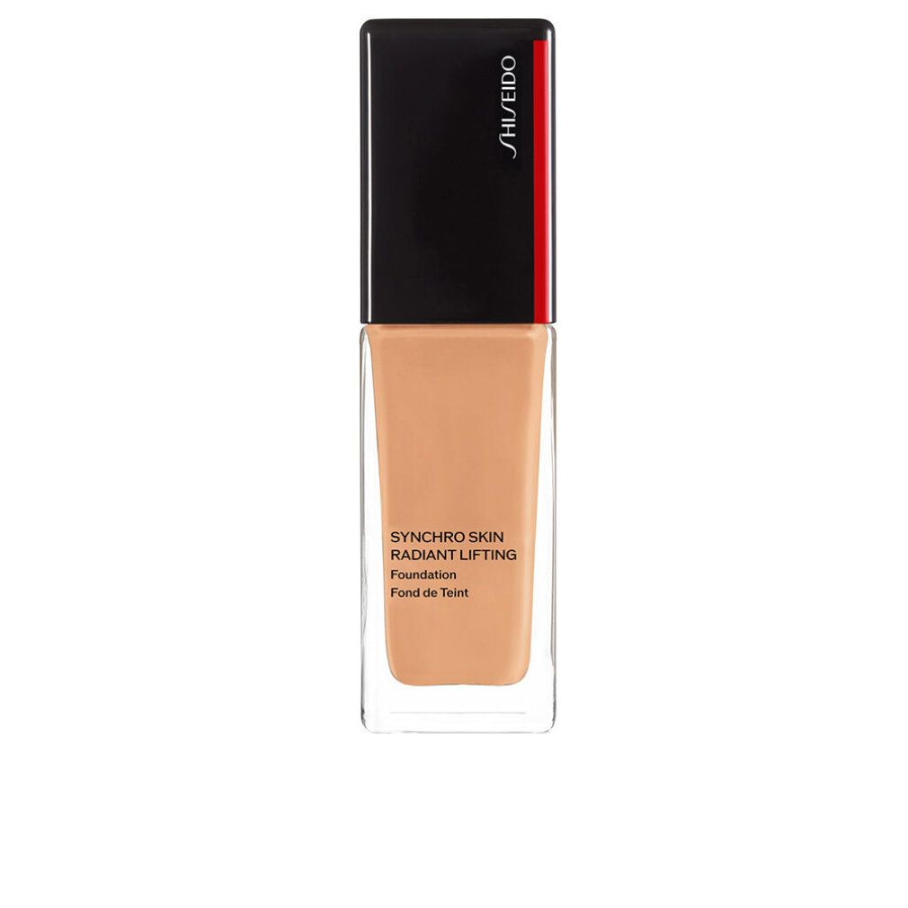 Flacon de fond de teint. Bouchon noir avec bande rouge. Inscription: Synchro Skin Radiant Lifting Foundation. Teinte.