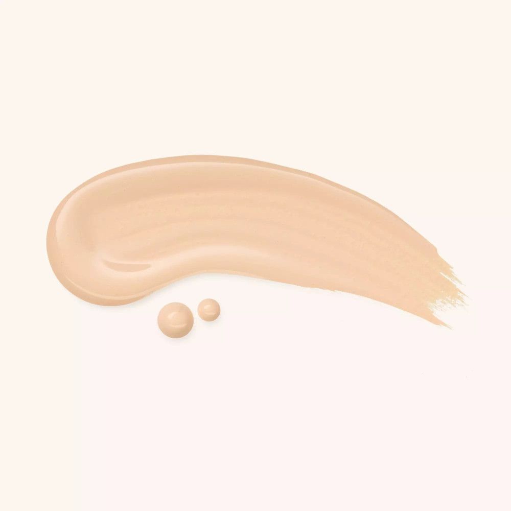 Nuance claire de Catrice Nude Drop Foundation sur fond clair. Deux gouttes et une trace.