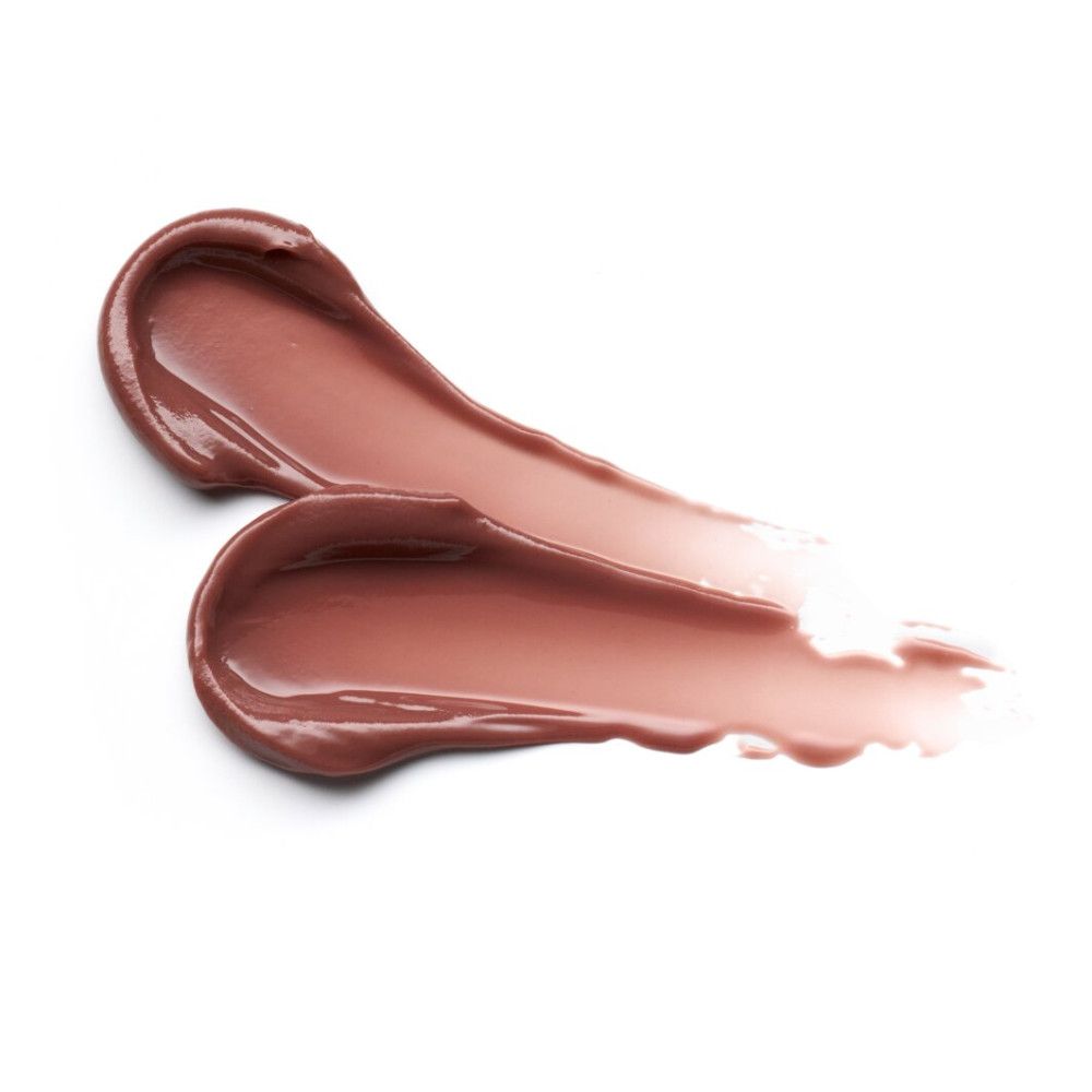 Deux traits de baume à lèvres crème sur fond blanc. Texture brillante.