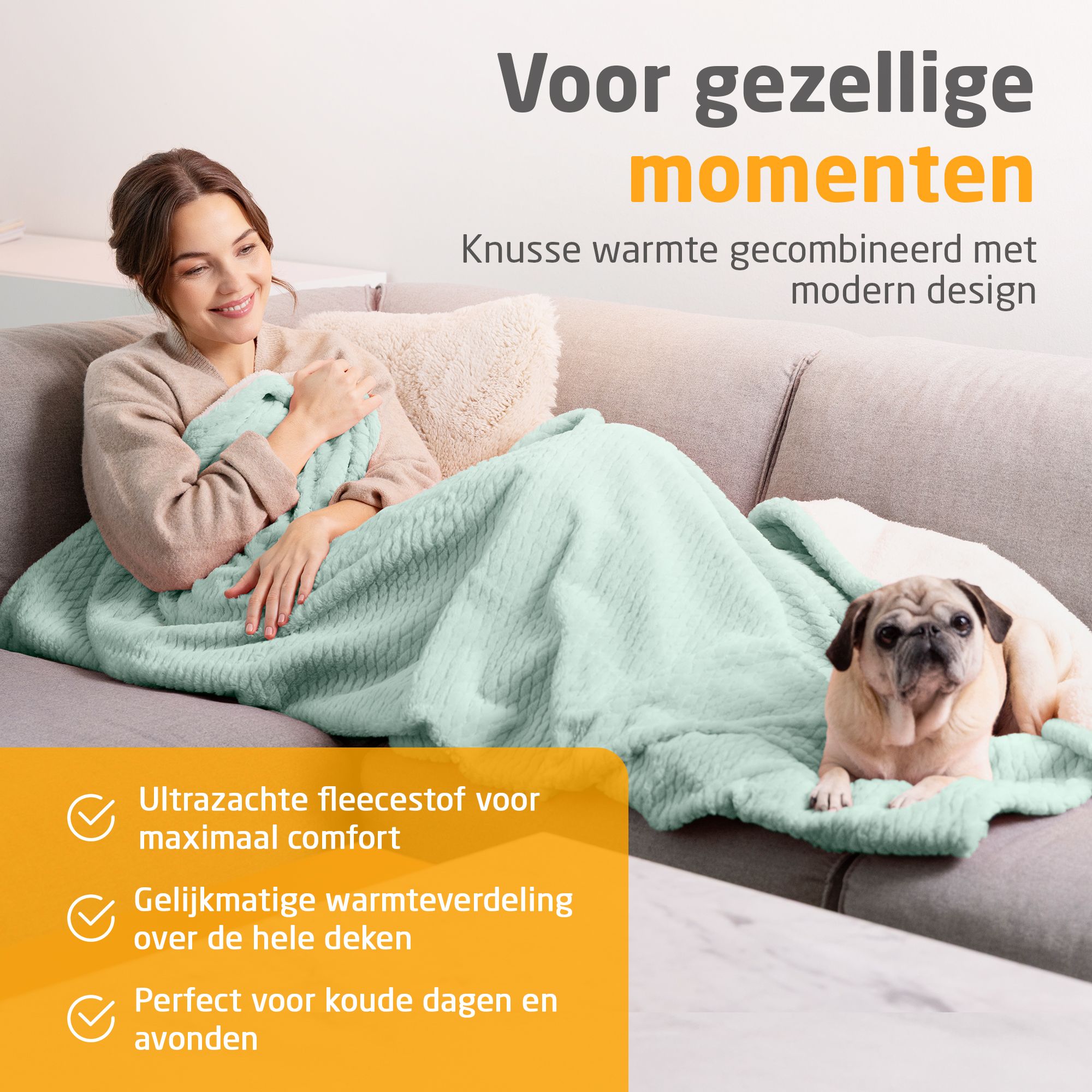 Persoon op bank met verwarmde deken, savage green. Zachte fleece. Hond ernaast. Tekst: Voor gezellige momenten.