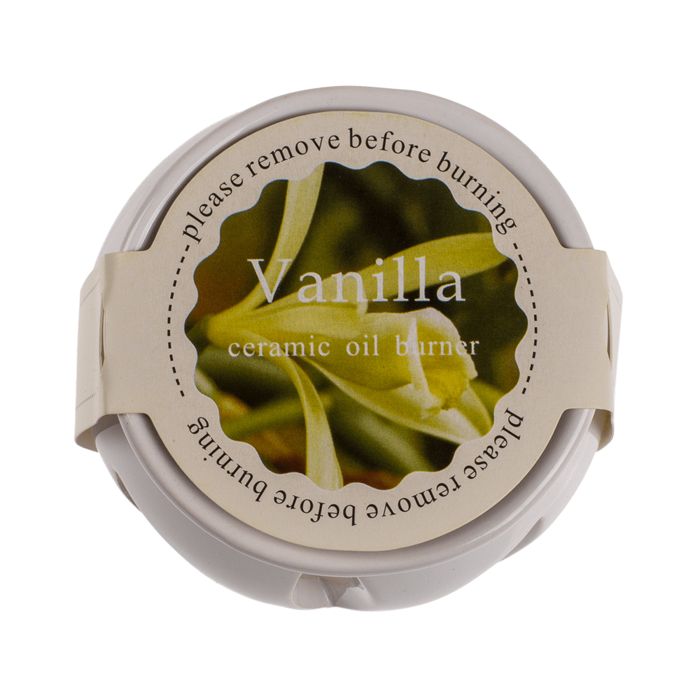 Ronde geurmelt-container met beige etiket. Opschrift 'Vanilla' en 'ceramic oil burner'. 'Verwijder voor het branden'.