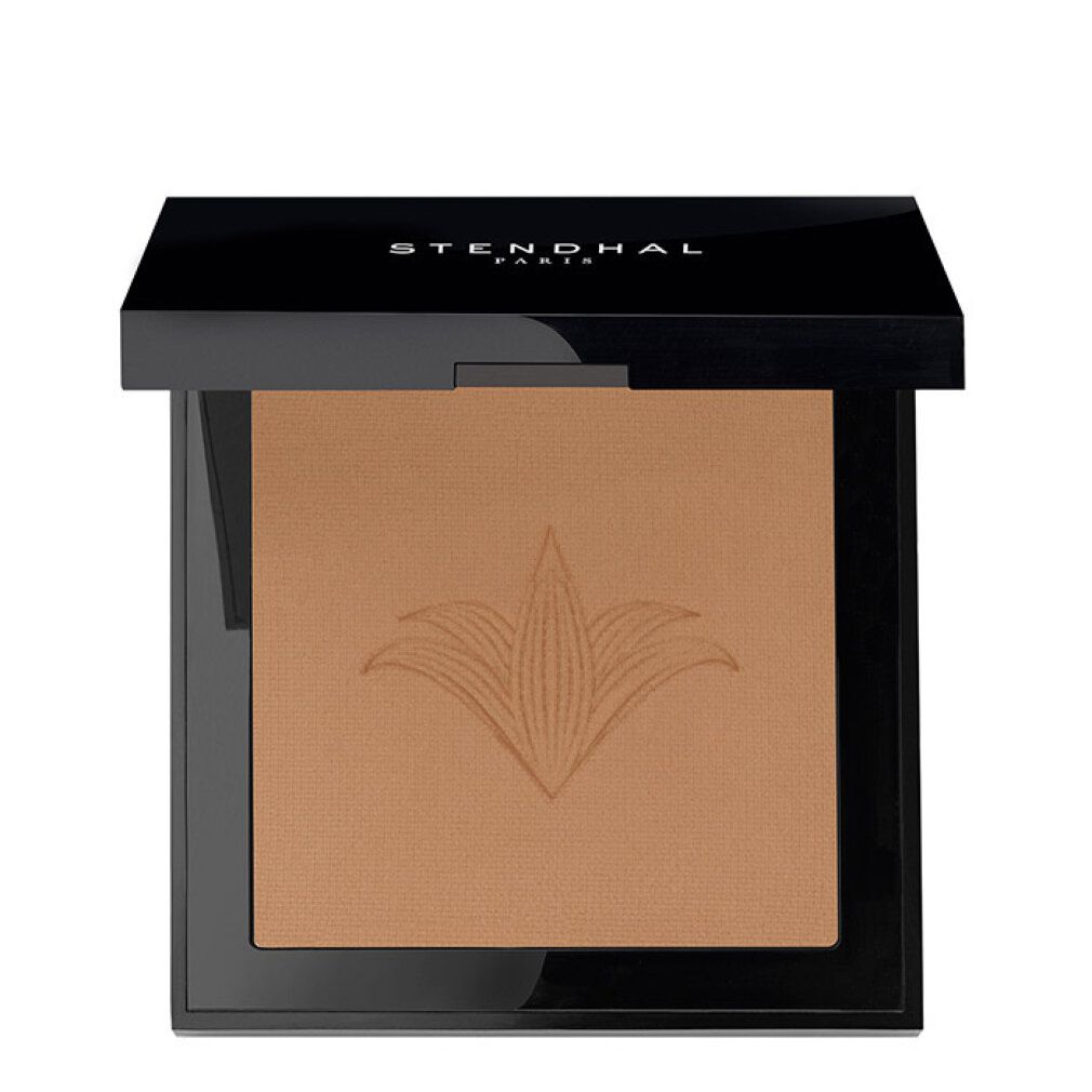 Poudre compacte dans un boîtier noir avec un motif floral gravé.