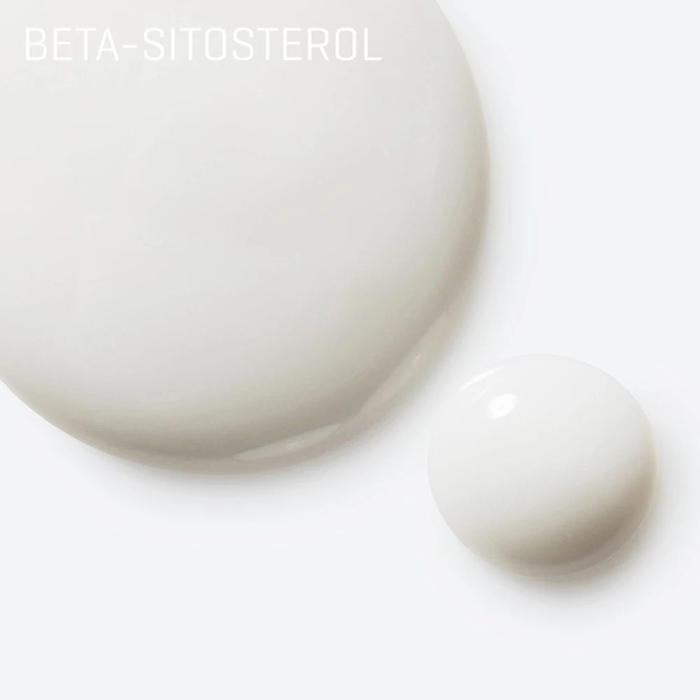 Gros plan de deux gouttes de sérum blanc. Inscription: Beta-Sitosterol. Fond blanc.