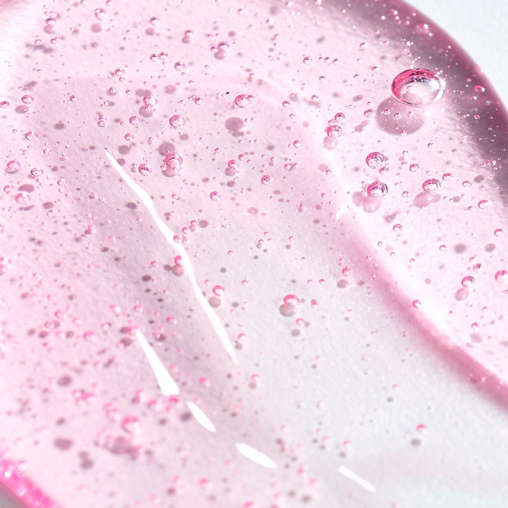Roze geltextuur met kleine belletjes, close-up.