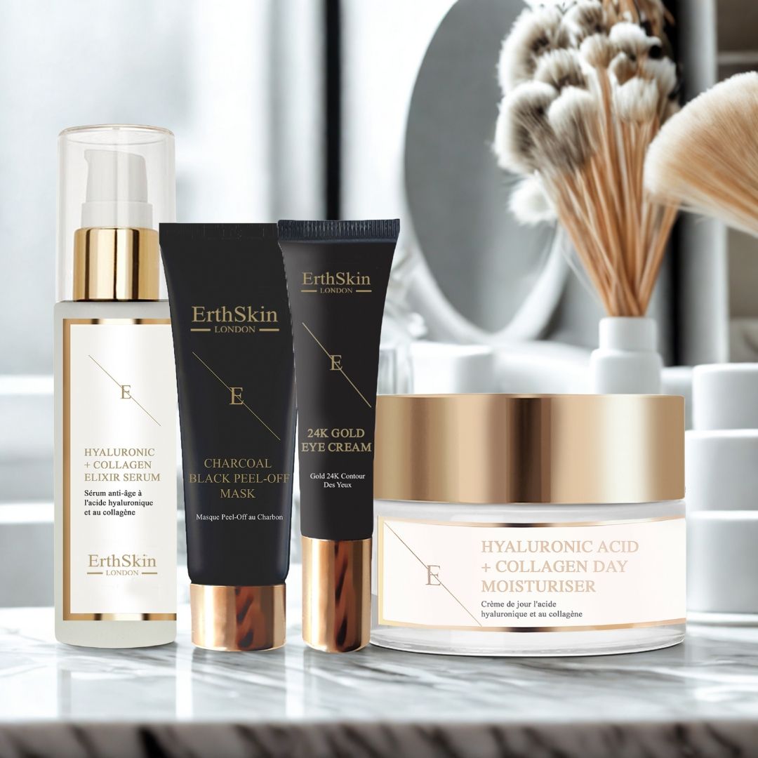 Produits cosmétiques : sérum, masque, crème pour les yeux et crème de jour. Emballages noirs et dorés. Texte : ErthSkin London. Sur marbre.